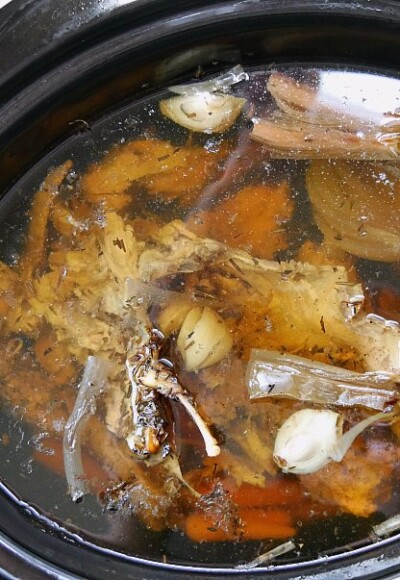 Old chicken bones and scrap vegetables are cooked down in to a delicious chicken broth.