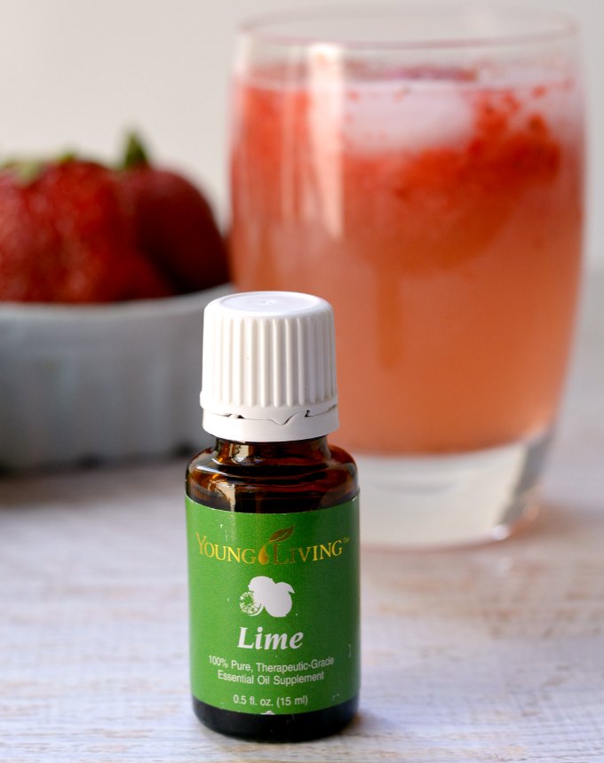 A quick and easy limeade recipe using fresh strawberries and lime essential oil for a refreshing summer drink!