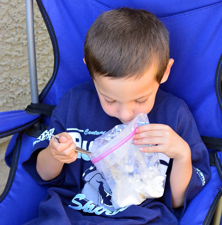 boy eating homemade ice cream out of a bag