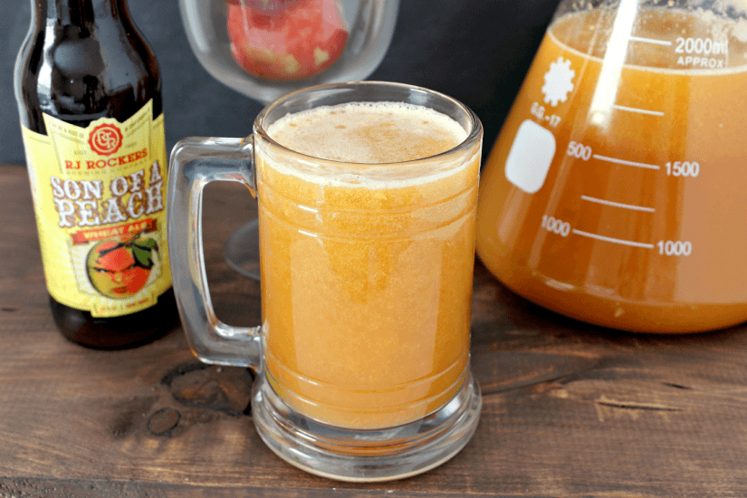Peach Beermosas --- Peach beermosas are a refreshing, fun, and interesting summer drink. They're bound to be a conversation starter at your next barbecue! || via growingupgabel.com #peach #beer #beverages #drinks #recipes #beermosas #cocktails #summer #outdoors #entertaining #party #barbecue