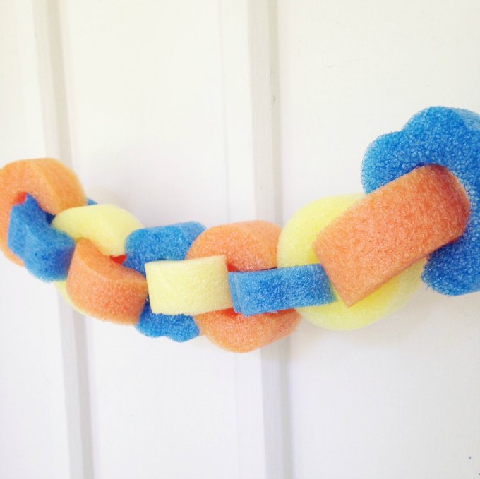 Make a fun dollar stores pool noodle garland for summer pool parties! A fun pool noodle craft, this DIY project is easy for the kids to help make, too.