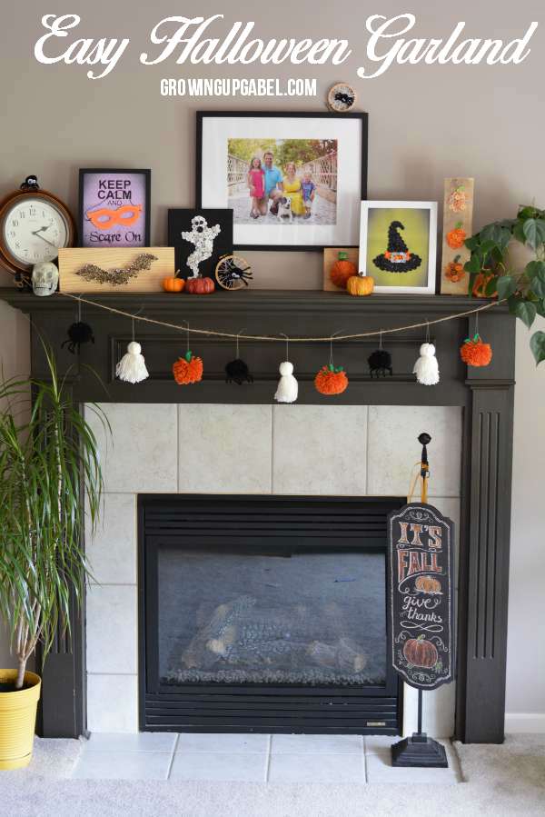 Mantle decorated for Halloween with yarn garland. 