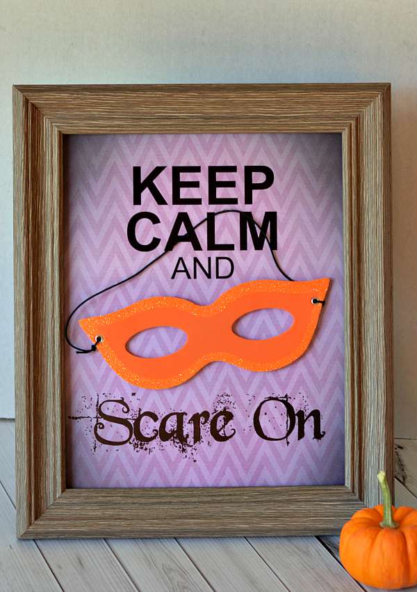 Keep calm and scare on poster in a frame on a table