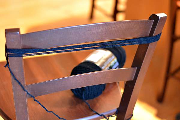 Black yarn wound around a chair.