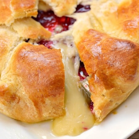 Need a quick and easy appetizer recipe? This Cranberry and Brie Baked Cheese Appetizer Recipe only needs 3 ingredients and comes together in about 30 minutes!