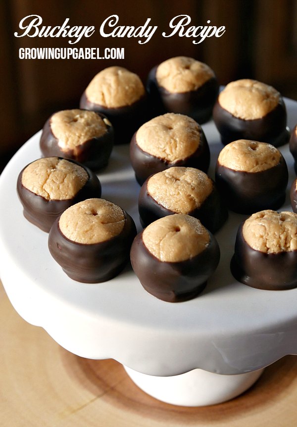 Peanut butter, powdered sugar and butter are mixed in to balls, and then dipped in chocolate for an AMAZING candy recipe. This easy buckeye candy recipe includes tips and tricks for getting the chocolate coating perfect for Buckeye Candy!