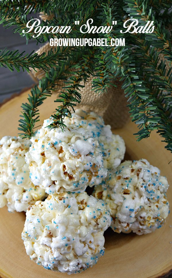 Bring the cold inside and make snowballs with an easy marshmallow popcorn ball recipe! A few simple ingredients and about 15 minutes are all you need to make a fun winter treat everyone will love. 