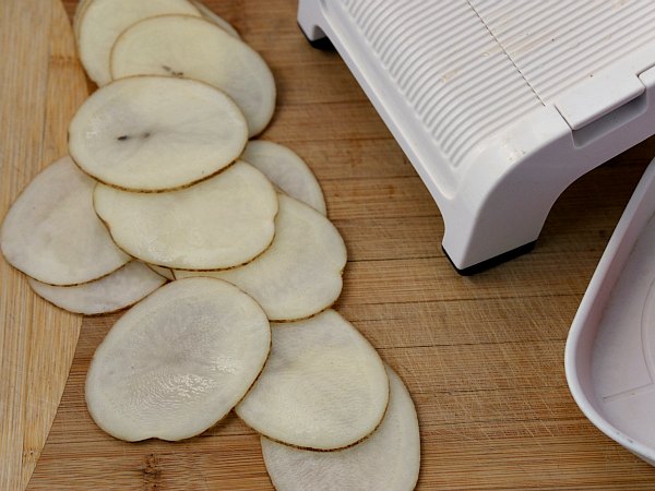 raw potato slices sliced by a mandolin