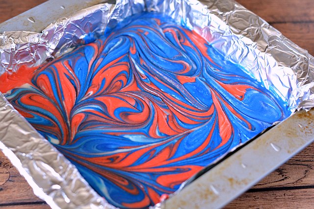 red and blue fudge swirled together in a pan