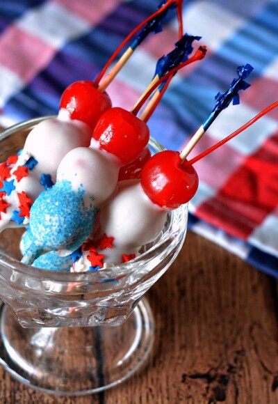 A fourth of July dessert is made even more fun with white chocolate, cherries and sprinkles!