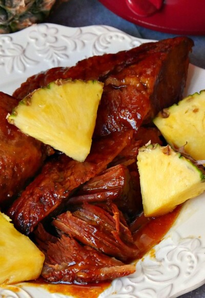 Pineapple glazed ham cooked in the Crock Pot is served with fresh pineapple on the side. Great for Easter!