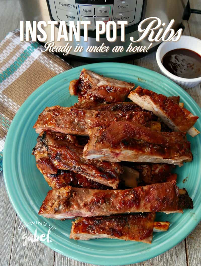 Plate of cooked pork spare ribs with an Instant Pot, towel and barbecue sauce.