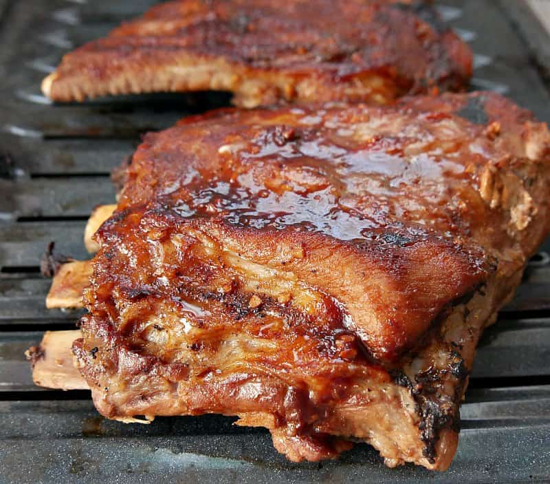 Spare ribs on a broiling pan with barbecue sauce after being cooked in Instant Pot and browned under broiler. 