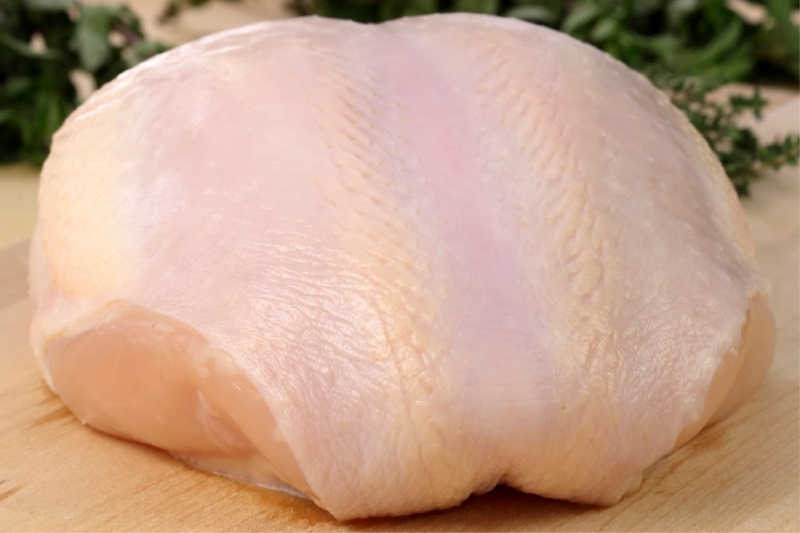 raw and juicy turkey breast with herbs on background fresh and healthy food