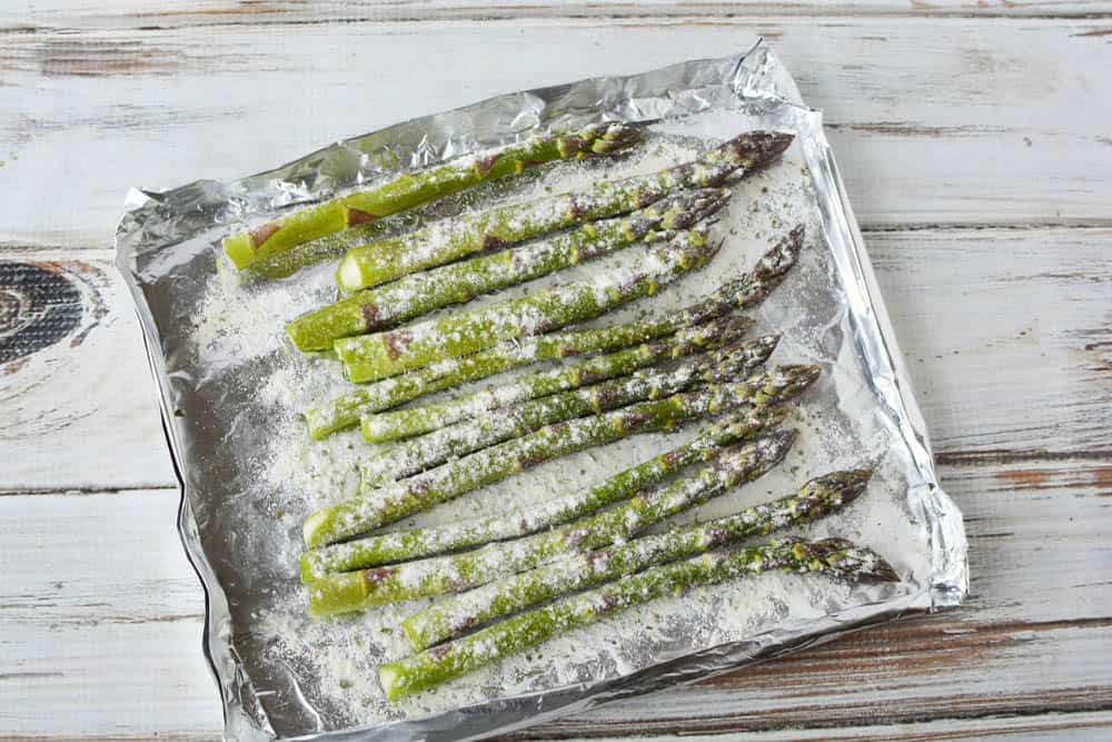 Asparagus on foil covered with dressing mix.