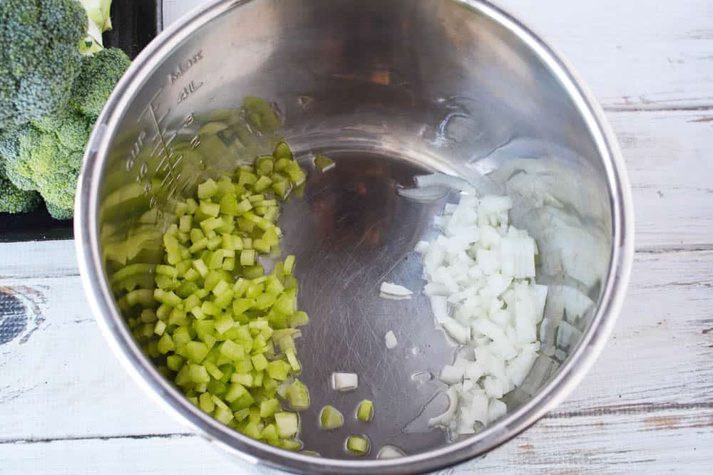 Diced celery and onions in the insert of an Instant Pot