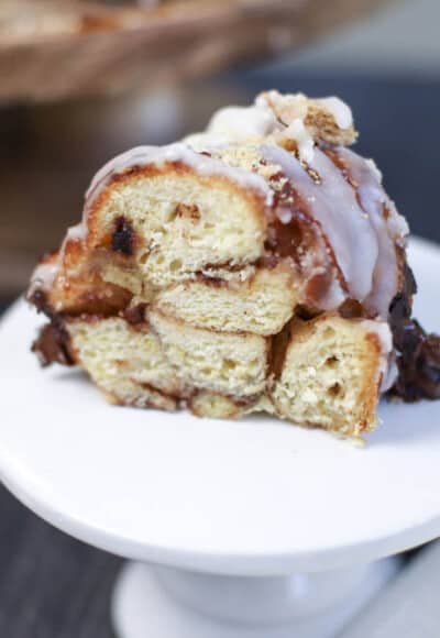 a slice of s'mores monkey bread on a small white cake plate