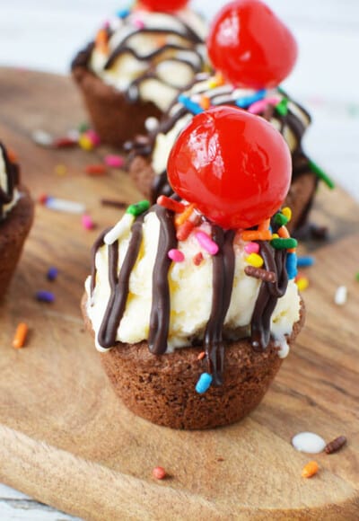 Chocolate peanut butter cookie cups with ice cream and cherry on top