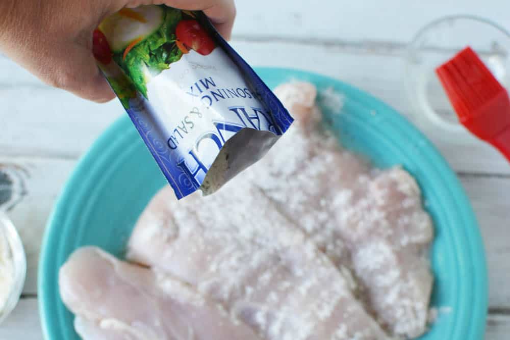 Sprinkling ranch dressing mix on chicken breasts