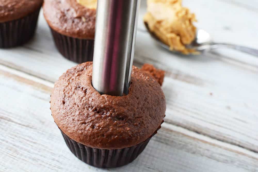Apple corer hollowing out a chocolate cupcake