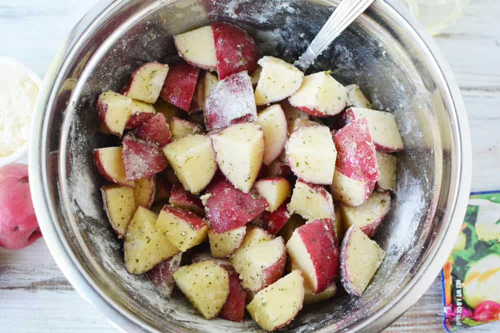 bowl of red potatoes covered in oil and ranch dressing mix