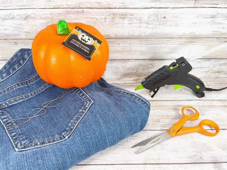 Foam pumpkin, jeans, hot glue gun, scissors