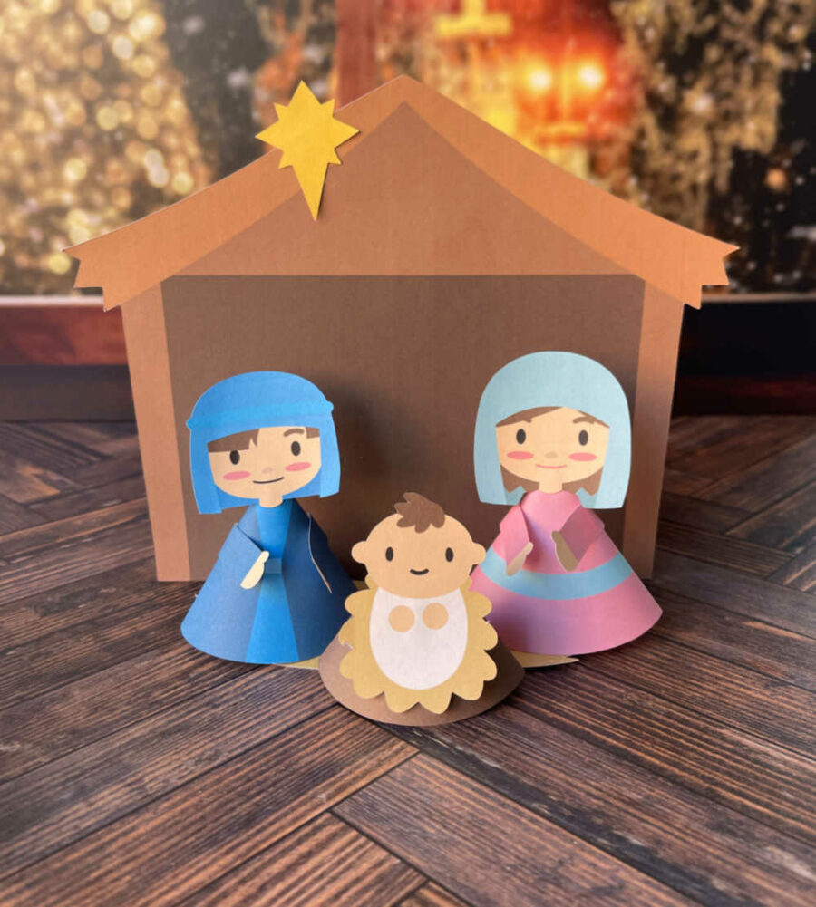 Mary, Joseph and baby Jesus in front of manger