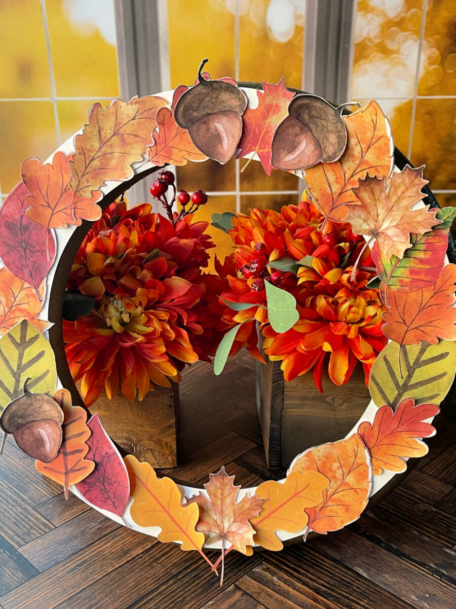 Finished gratitude wreath in front of fall flowers and a window
