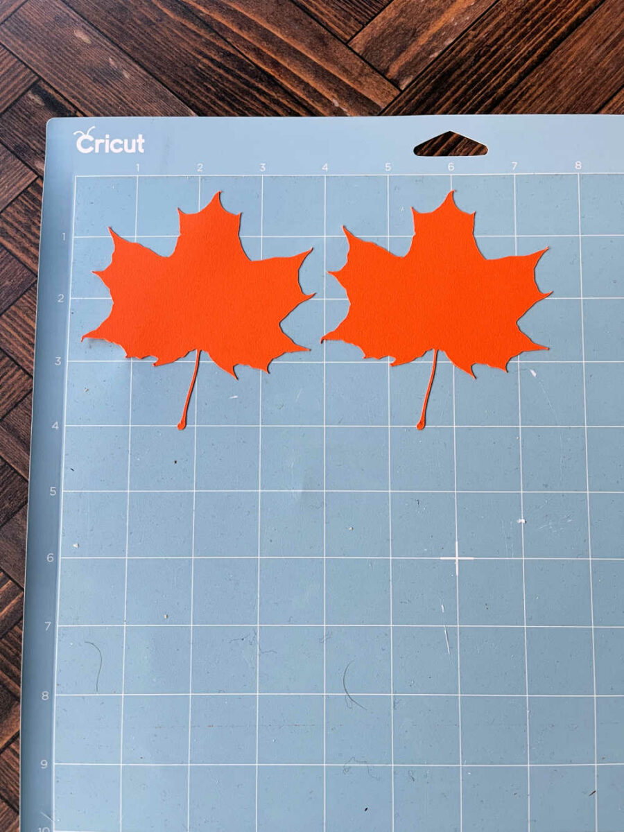 Orange paper leaves on Cricut cutting mat