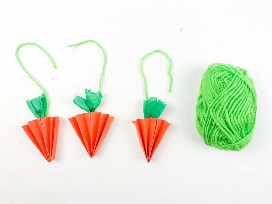 Paper carrots and green yarn