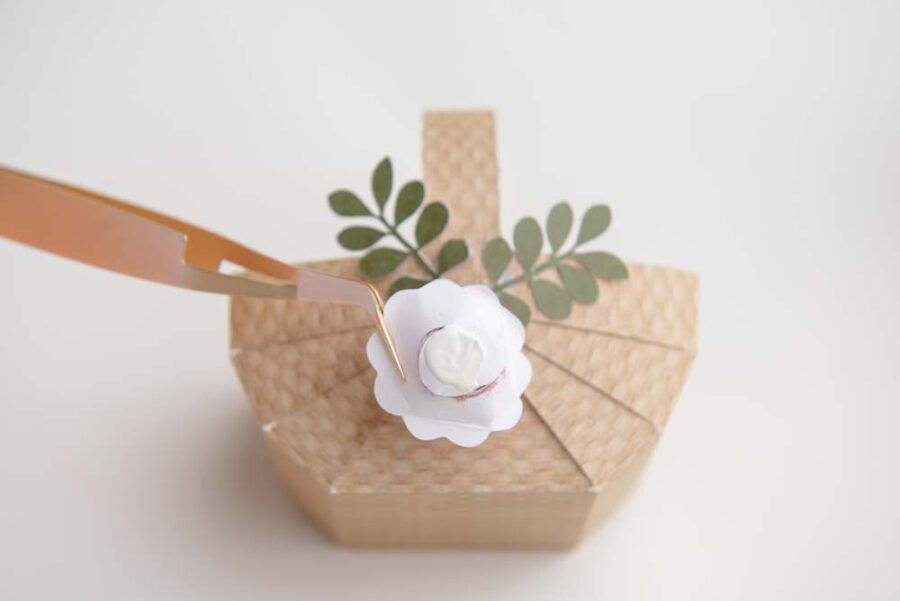 Gluing paper flower on paper basket