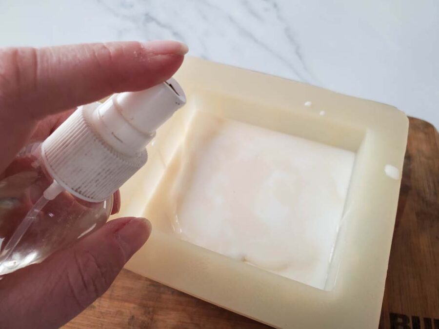 Spraying soap mold with rubbing alcohol
