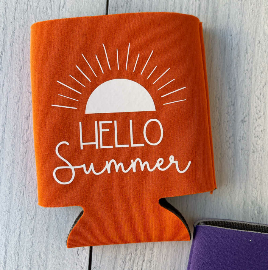 Orange Hello Summer Can Koozie on laying flat on a table