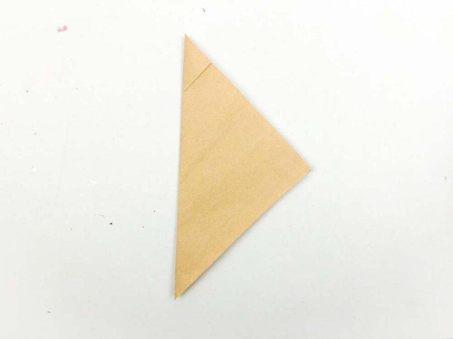 Brown piece of paper folded into a triangle
