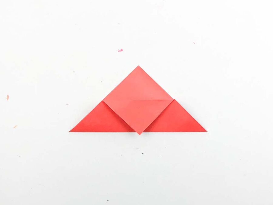 Red paper triangle with tip folded down in front