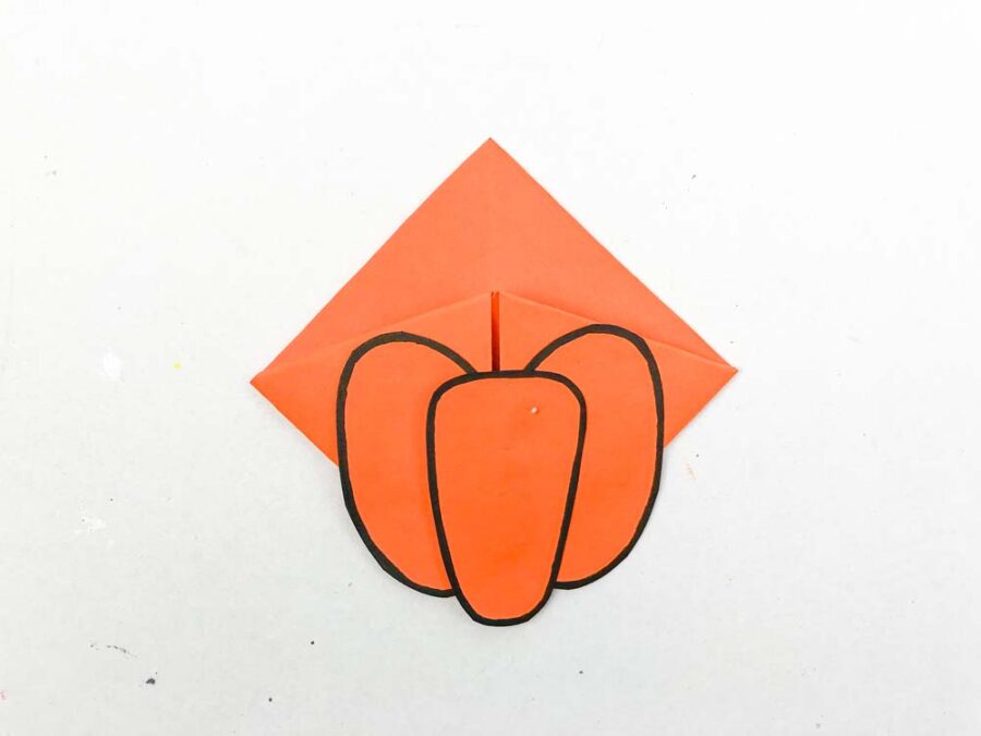 Pumpkin glued to the orange origami corner bookmark.
