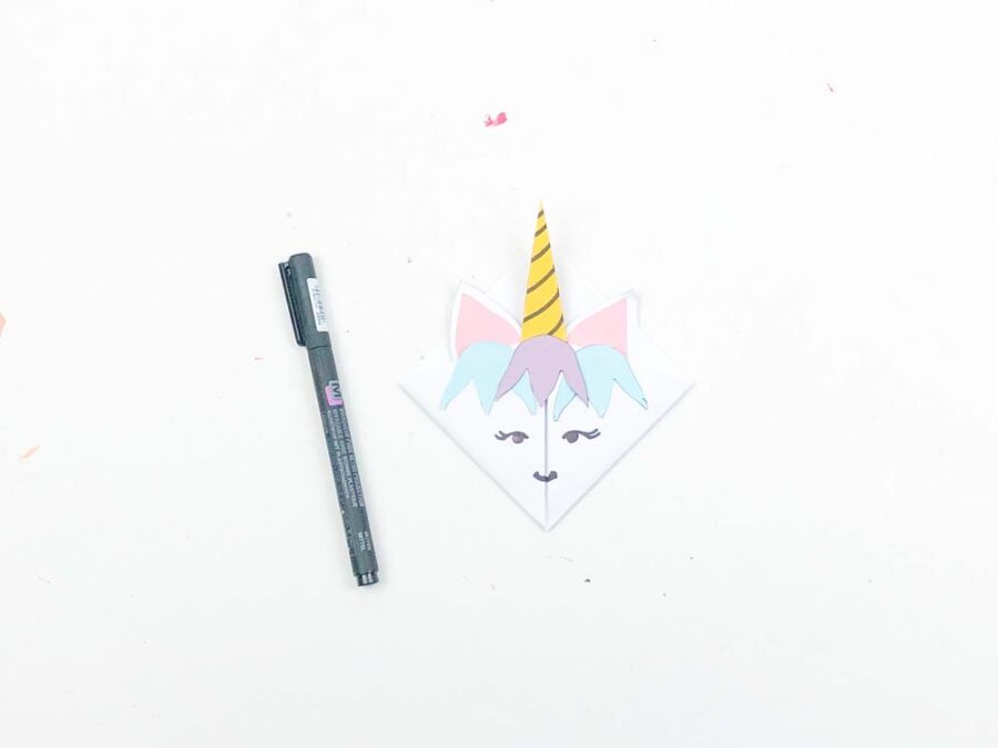 Unicorn bookmark with face drawn on