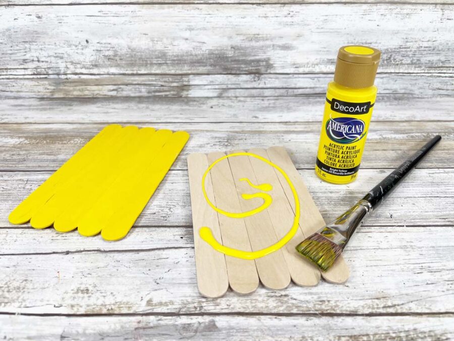Craft sticks and yellow craft paint