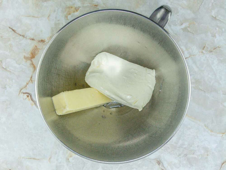 Cream cheese and butter in a mixing bowl.