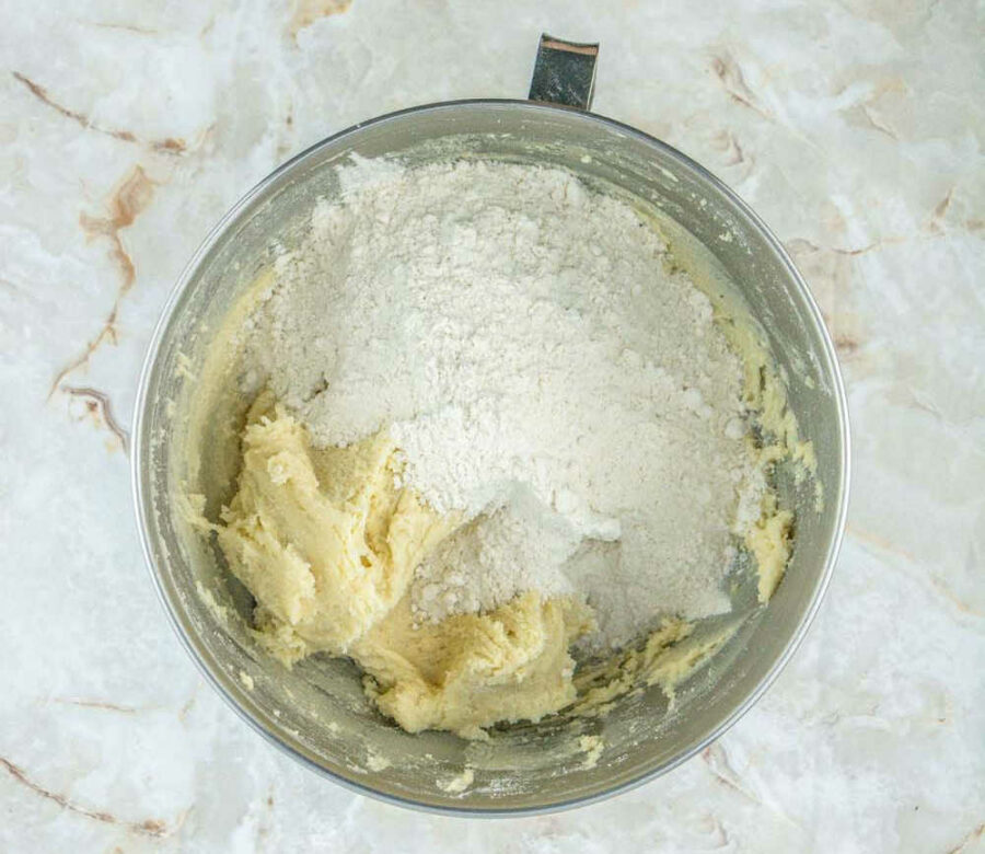 Flour and cookie dough in a mixing bowl