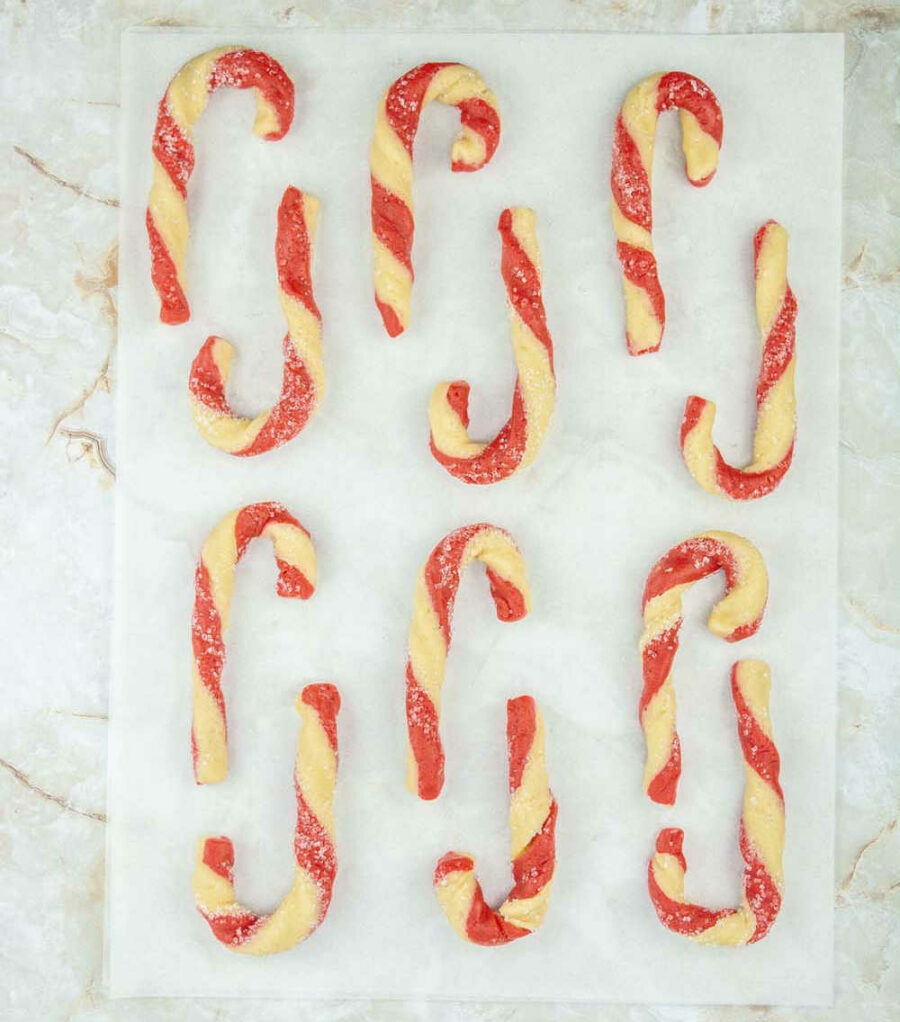Unbaked cookies in candy cane shapes