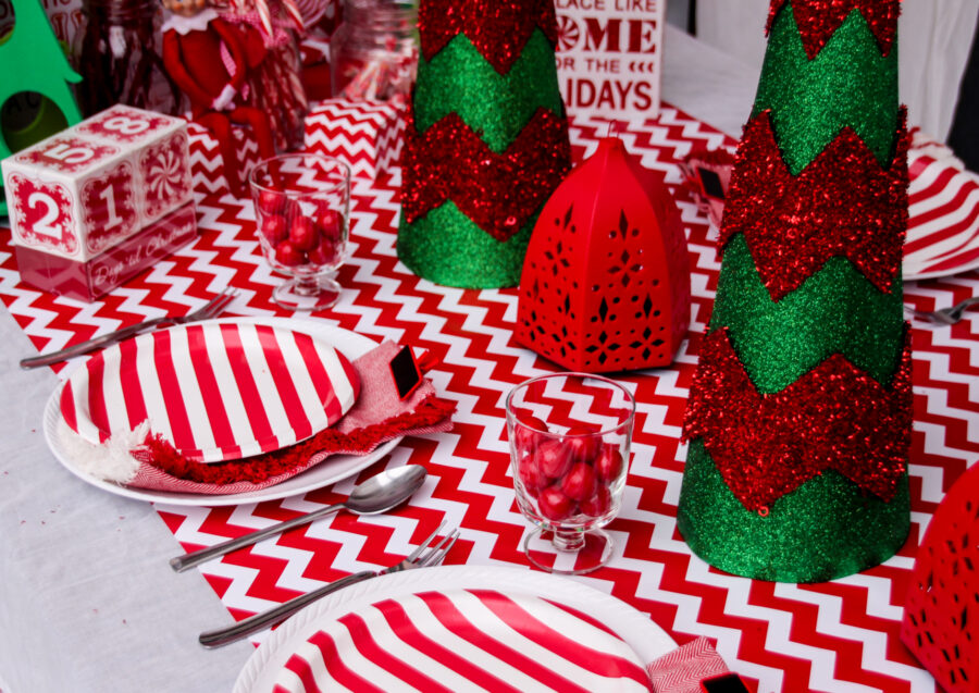 Red and white striped tablescape for an elf welcome party