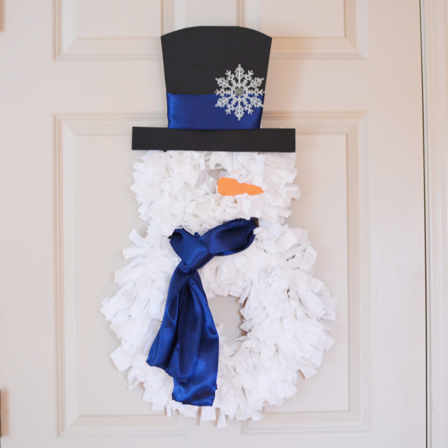 Snowman rag wreath hanging on a door