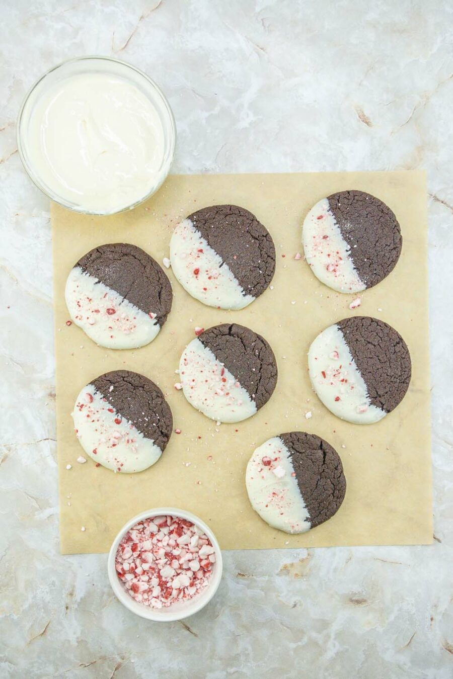 White Chocolate Dipped Chocolate Peppermint Cookies on parchment