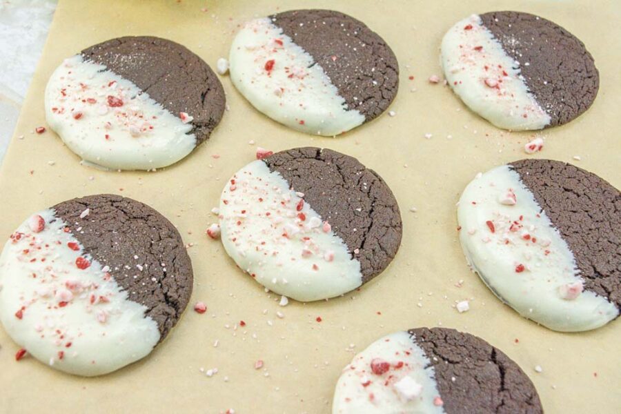 White Chocolate Dipped Chocolate Peppermint Cookies on parchment close up