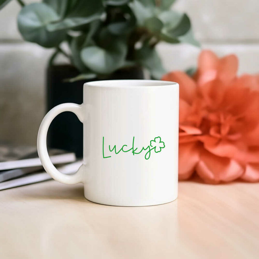 White mug with green lucky written on it