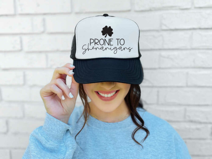 Woman wearing a hat saying prone to shenanigans